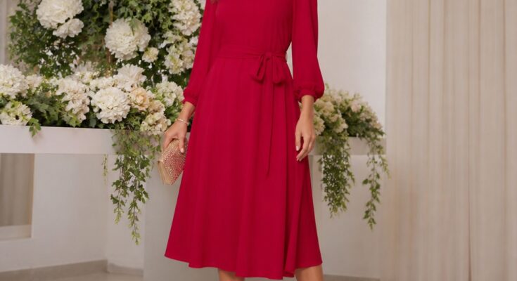 Vestido de festa vermelho em uma mulher elegante, em ambiente iluminado com flores ao fundo, pose confiante.