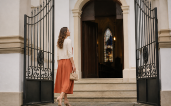 Mulher com vestido midi discreto e elegante caminhando em direcao a igreja classica iluminada